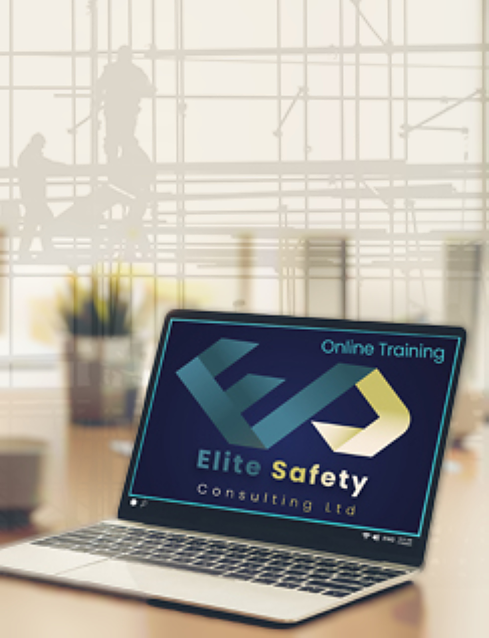 The Elite Safety Consulting Ltd logo on a laptop screen reading Online Training, in a bright office with workers on scaffolding fading into the background.
