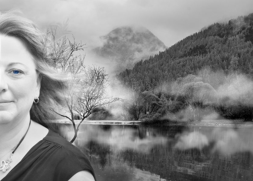 Black and white portrait of a woman beside a misty lake, for a grief counselling practice.